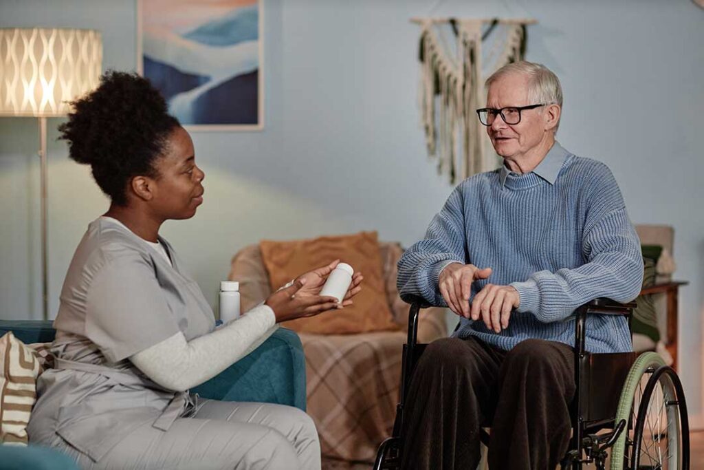 Older couple sits together in an accessible apartment while reviewing a daily care schedule.