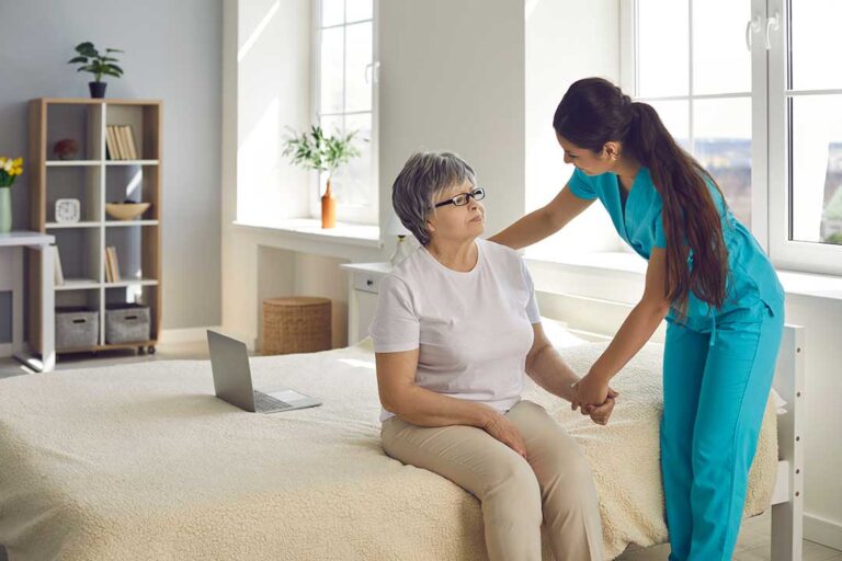 Older adult and family member arranging personal belongings in a bright assisted living room