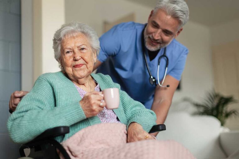 Older adult and family member arranging familiar belongings in a bright assisted living room.